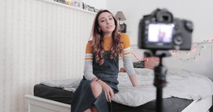 Vlogger recording youtube video in bedroom with camera