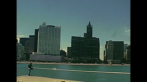 Chicago, Lake Michigan,Illinois, United States - Circa 1977:waterfront with people looking Chicago skyline in 70s. Vintage dress of people. Historical United States of America in Milton Lee Olive Park