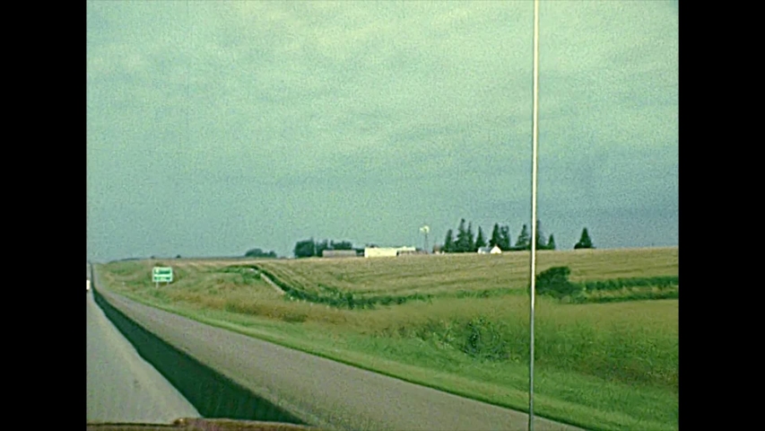 Minnesota State Highway MN 43 to Rushford town in the countryside with local buildings and farms. United States in the 1970s. The historical United States of America.