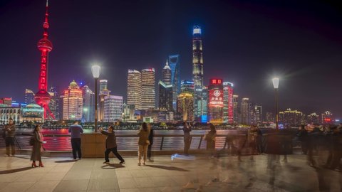 CHINA, SHANGHAI - APRIL 1, 2019. Day to Night Timelapse or Hyperlapse View of Oriental Pearl Tower Financial Center Pudong. Shanghai Tower on the Bund by Huangpu River. Motion Blur Along Riverfront.