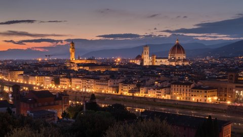 Amazing sunset view of Florence city, Italy with the river Arno, Ponte Vecchio, Palazzo Vecchio and Cathedral of Santa Maria del Fiore (Duomo). Panoramic time lapse from day to night.