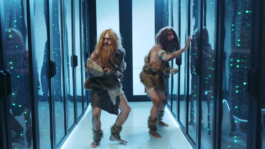 Wild cave people of hunter-gatherers walking into data center, discovering technology for first time. Tribe of primal humans exploring modern civilization in cyber security data center. - Powered by Shutterstock - Get 15% off with code: PIKWIZARD15