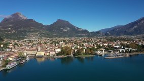 Aerial video with drone. Panoramic view of the alps Lake Garda and the city of Riva del Garda, Italy. Blue sky