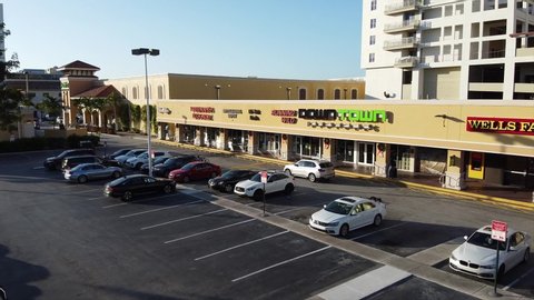 FORT LAUDERDALE, FL, USA - DECEMBER 1, 2019: Aerial video stores in a strip mall shopping plaza