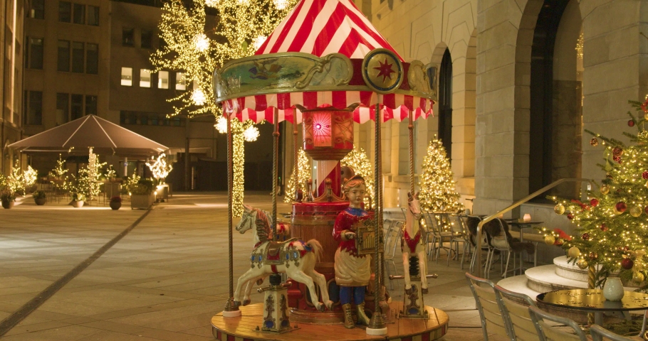 Carousel in the park at night. Glowing trees. Christmas eve. New Year. Zurich. Switzerland.