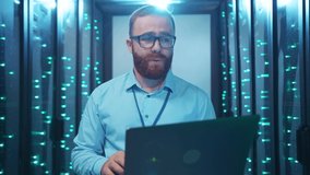 Caucasian IT engineer working on laptop turning off digital server room typing keyboard in panic trying to solve problem. Data center blackout. Power failure. - Powered by Shutterstock - Get 15% off with code: PIKWIZARD15