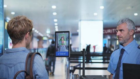 face detection system woman goes through the facial recognition control at airport security check