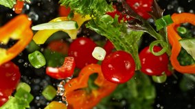 Super Slow Motion Shot of Flying Cuts of Colorful Vegetables and Water Drops on Black background at 1000fps. - Powered by Shutterstock - Get 15% off with code: PIKWIZARD15
