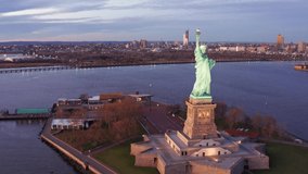 Slow drone panning along The Statue of Liberty, Jersey City and New York City skylines. The Statue of Liberty is a colossal neoclassical sculpture on Liberty Island in New York Harbor.