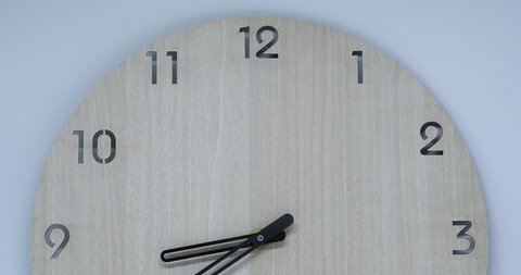 Timelapse, time lapse of clock on wooden background and movement of clock hands. Royalty high-quality 4k stock video footage time lapse clock with three arrow hands moving fast to 9 10 11 12 hours