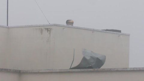 Strong wind tears away roofing from house during strongest powerful hurricane Damrey rushing over Vietnam