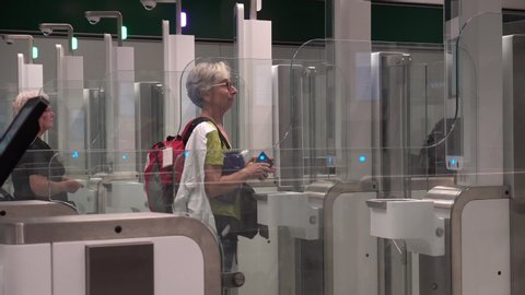 Air travelers pass through automated passport border control gates Milano Malpensa Airport. Electronic automatic passport check Italy border in Milan Malpensa airport. Italy Milan September 17, 2019