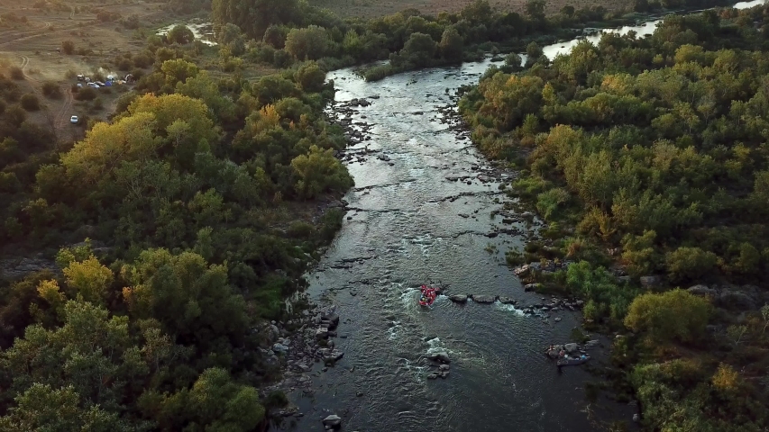 people on the River rafts at sunset, people on the rafts on mountain river, river rafting,  Rafters Running The Rapids,  Rafting Team on the river
