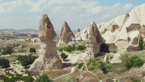 Cappadocia, famous rocks in Goreme National Park and Love Valley at summer sunny day / Aerial drone view