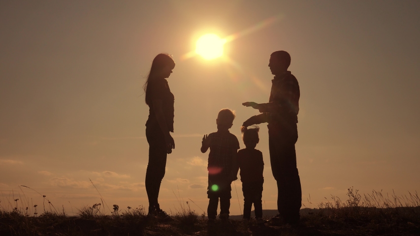 happy family teamwork silhouette shows a house and comfort symbol at sunset. mom dad and kids children portray a house roof hold their hands over their heads lifestyle Royalty-Free Stock Footage #1042265263