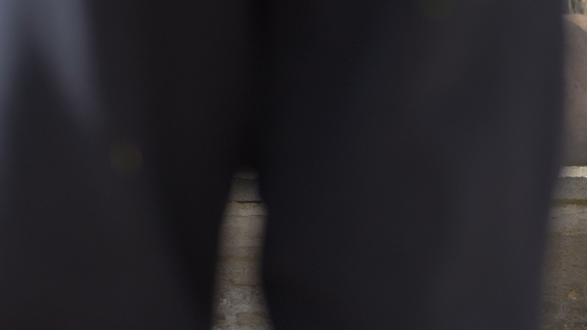 blind person sitting on wall in a park. orientation, autonomy, handicap