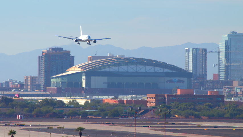 Generic Air Cargo Boeing 767 Freighter Airplane Landing Over Phoenix AZ Downtown Building Cityscape with White Tire Smoke when Touching Down on a Sunny Day in Arizona Royalty-Free Stock Footage #1042278139