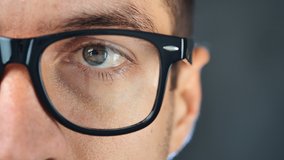 Macro eye of man in eyeglasses. Close up eye of businessman or student in glasses
