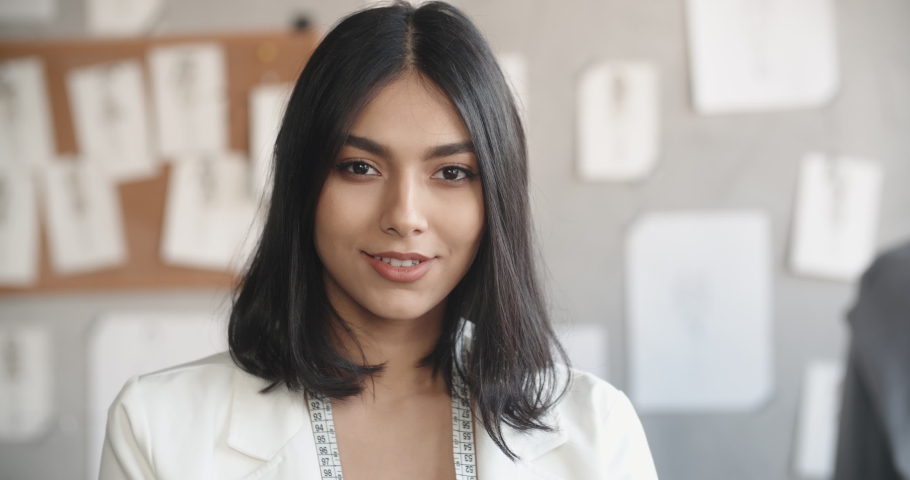 Close-up portrait of successful female clothes designer at her office, looking at camera and smiling - fashion concept 4k footage | Shutterstock HD Video #1042281049
