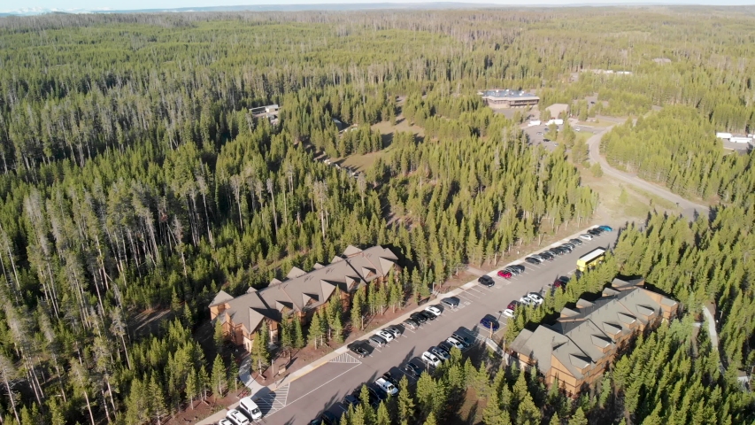 Amazing panoramic aerial view of Yellowstone Lake with trees and car parking, Wyoming.