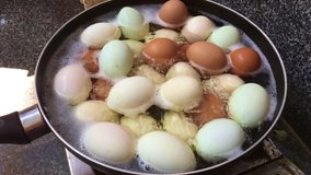 Slow motion video of cooking duck eggs and chicken eggs