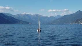 Aerial Drone Footage View Of Sailboat in Como’s lakes, Lecco lake, House on bay, in Lombardia Italy Europe Alps