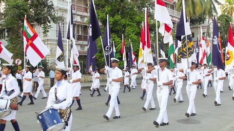 Mumbai, Maharashtra, India - December 3rd 2019 : Indian Navy Sailors performing a joint Parade with musical instruments and flags on occasion of Indian Navy Day 2019 at Mumbai's Gateway of India.
