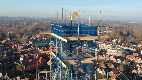 Church tower in the scaffolding for maintenance. Drone video of the church tower from Enkhuizen, Holland.