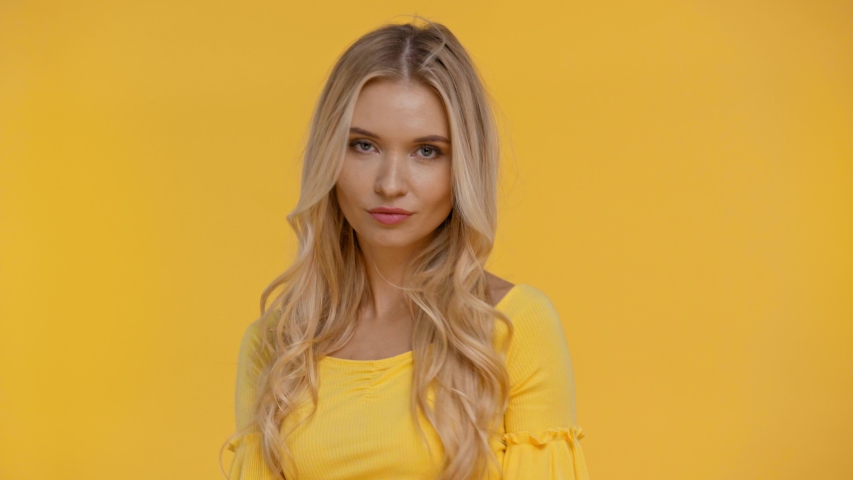 smiling woman posing isolated in yellow
