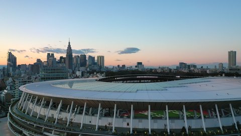 TOKYO, JAPAN - END OF 2019: Aerial view of New National Stadium, completed main stadium for Olympic Summer Games 2021 (originally 2020), skyscrapers skyline of modern district Shinjuku in background.