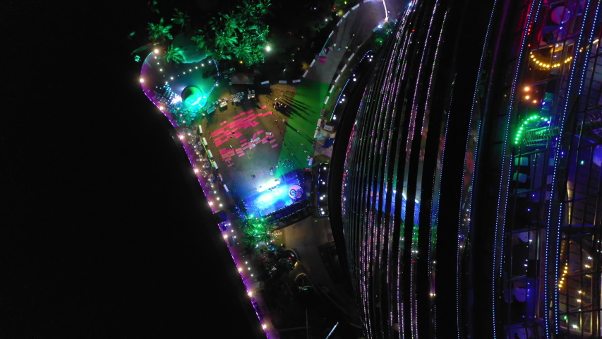 night illuminated sanya famous hotel resort yoga session buildings aerial topdown panorama 4k hainan china