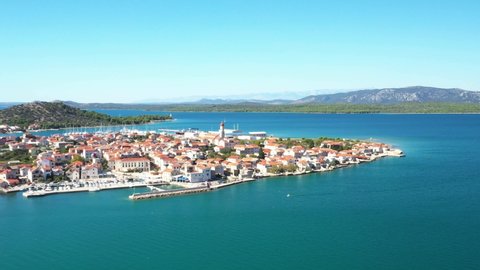 Croatia, Island of Murter, beautiful coastal touristic town of Betina on Adriatic sea, drone aerial circle footage