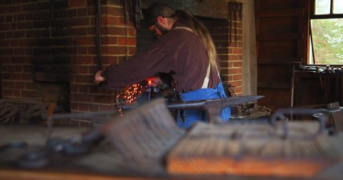 Mount Vernon, Virginia / USA - November 13, 2019: Historical Reenactment of Old Fashioned Blacksmith Shop, Slow Motion