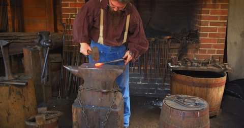 Mount Vernon, Virginia / USA - November 13, 2019: Old Fashioned Blacksmith With Hammer, Slow Motion