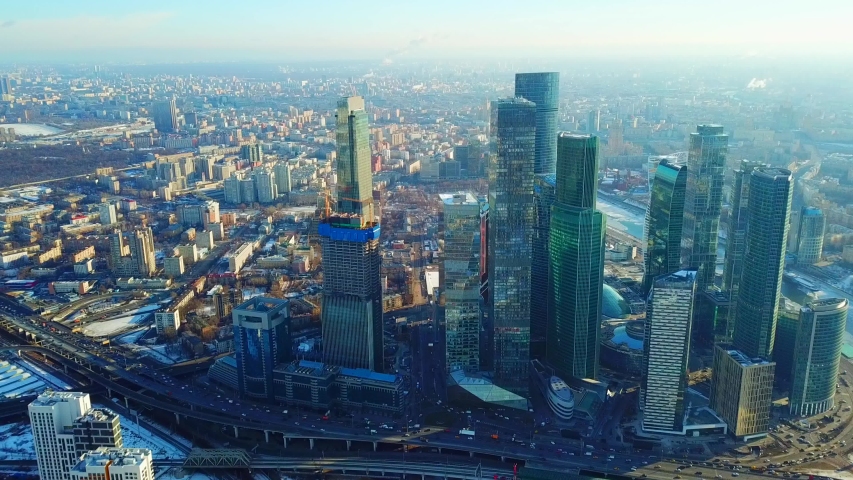 Moscow, Russia - 9 March 2019: Aerial top view of the skyscrapers of Moscow City. Moscow International Business Center. Taken by drone at spring day. Snow on the background | Shutterstock HD Video #1042342702