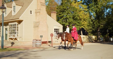 Williamsburg, Virginia / USA - November 17, 2019: Historical Actors & Reenactors Riding Horses in Colonial Williamsburg