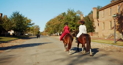 Williamsburg, Virginia / USA - November 17, 2019: Historical Actors & Reenactors in Costume on Horses in Colonial Williamsburg