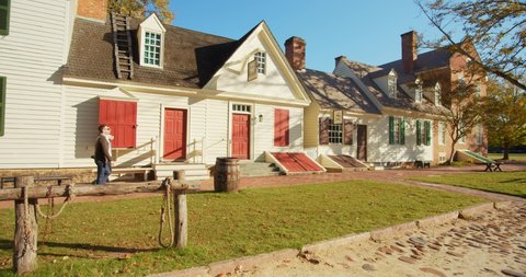 Williamsburg, Virginia / USA - November 17, 2019: Tourists Pass A Historical Colonial Williamsburg House, Exterior Shot