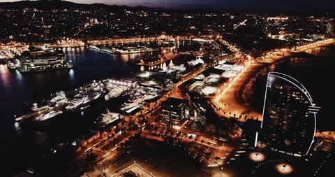 Aerial view of cityscape with Port Vell and hotel  on Barceloneta beach in night lights