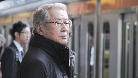 Tokyo , Kantõ / Japan - 06 23 2015: close up face shot of asian man at Tokyo train station