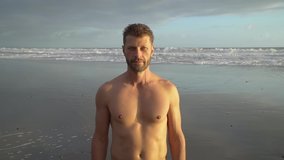Close-up of a young handsome unshaven man looking at the camera by the ocean - Powered by Shutterstock - Get 15% off with code: PIKWIZARD15
