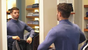 Young man trying on clothes in store