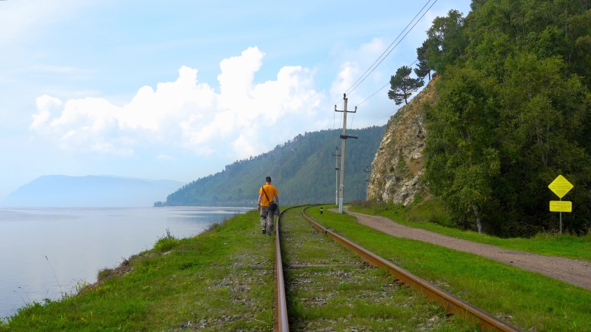 A man walks on the Circum-Baikal railway
