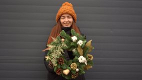 Beautiful caucasian girl and christmas wreath outdoors o na snowy day - Powered by Shutterstock - Get 15% off with code: PIKWIZARD15