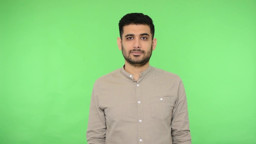 Positive brunette man with bristle in shirt showing zip lips gesture, meaning i won