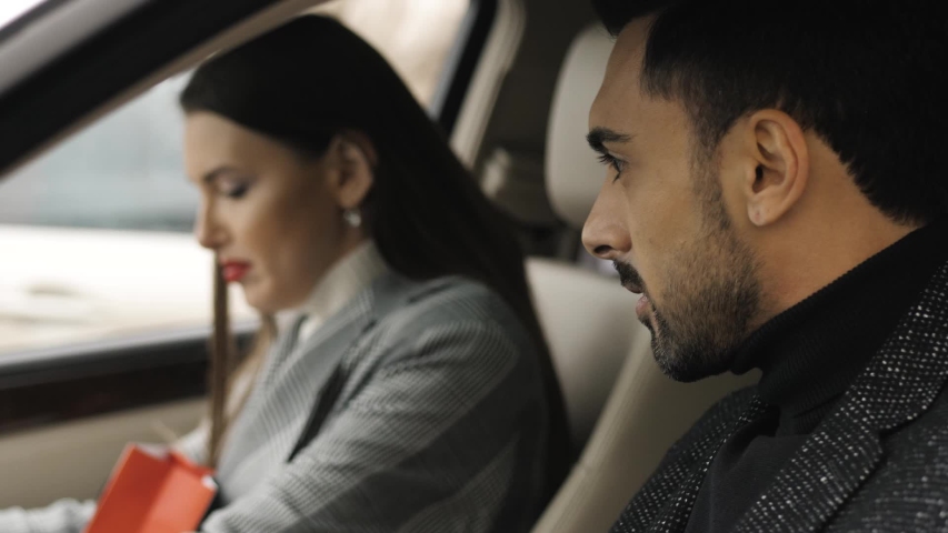 Young couple sitting in the car and cute talking | Shutterstock HD Video #1042379704