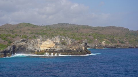 waves are breaking on the rocks at the Angel's Billabong beach at the Nusa Penida island, Indonesia