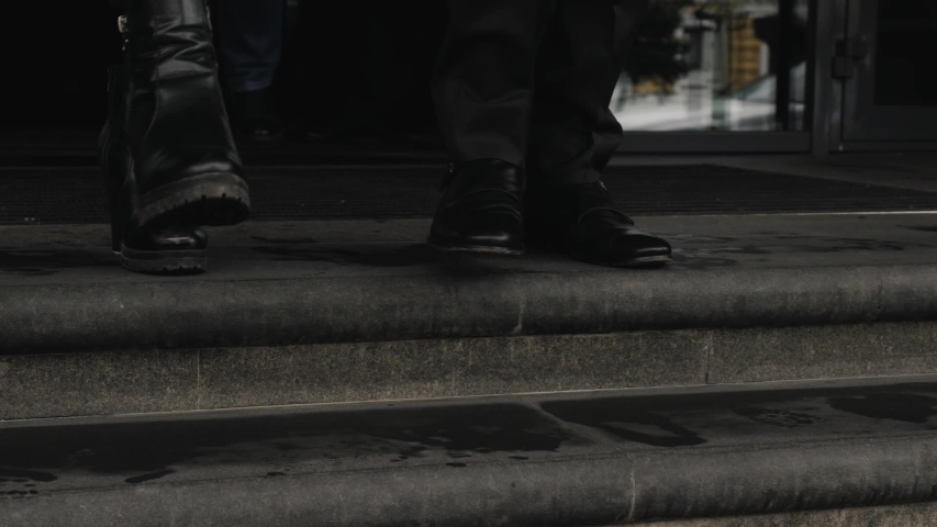 Male and female feet go down the stairs