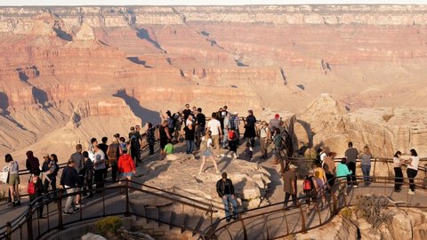 Grand Canyon, Arizona - October 17, 2019: Time lapse many tourists walk on observation Mather Point to take photo or selfie background of famous place Grand Canyon national park with amazing landscape