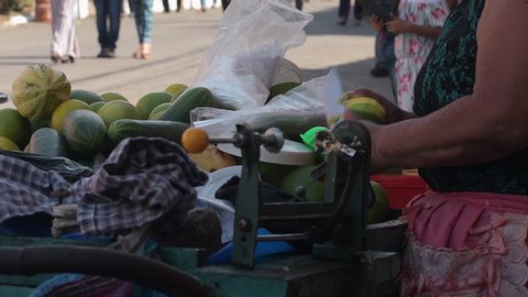 Chiquimulilla Guatemala 08/20/2019 latin woman cutting a mango in Guatemalan street market 
